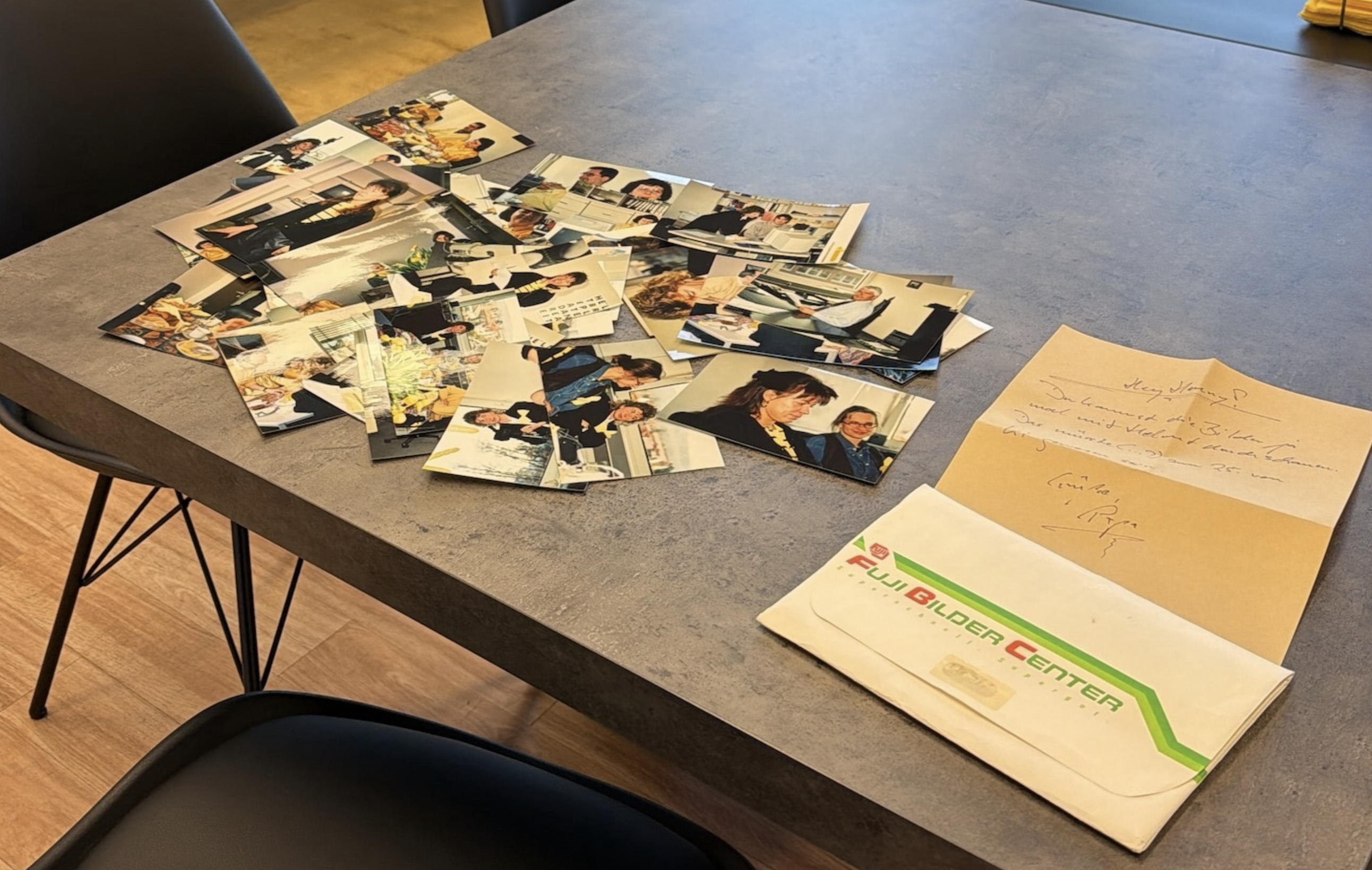 Historical photos and documents from the company archive on a table